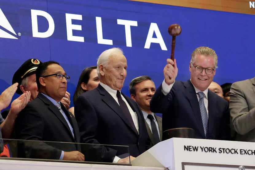 Delta Air Lines CEO Ed Bastian (right), accompanied by former CEO Jerry Grinstein (center),...