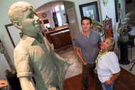 Bessie Rodriguez, far-right, mother of Santos Rodriguez, stands with sculptor Seth Vandable...