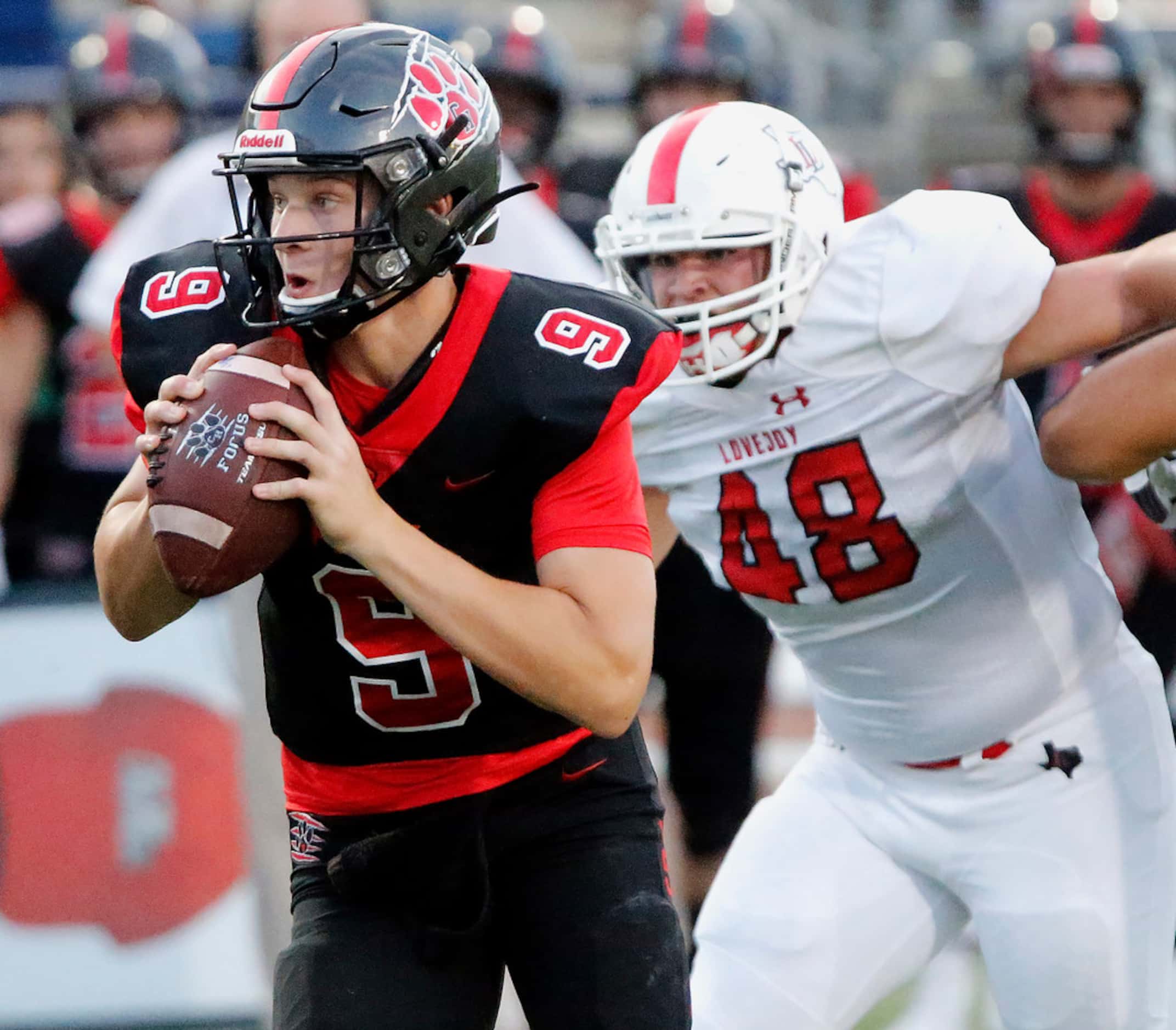 Colleyville Heritage High School quarterback AJ Smith (9) is pressured by Lovejoy High...