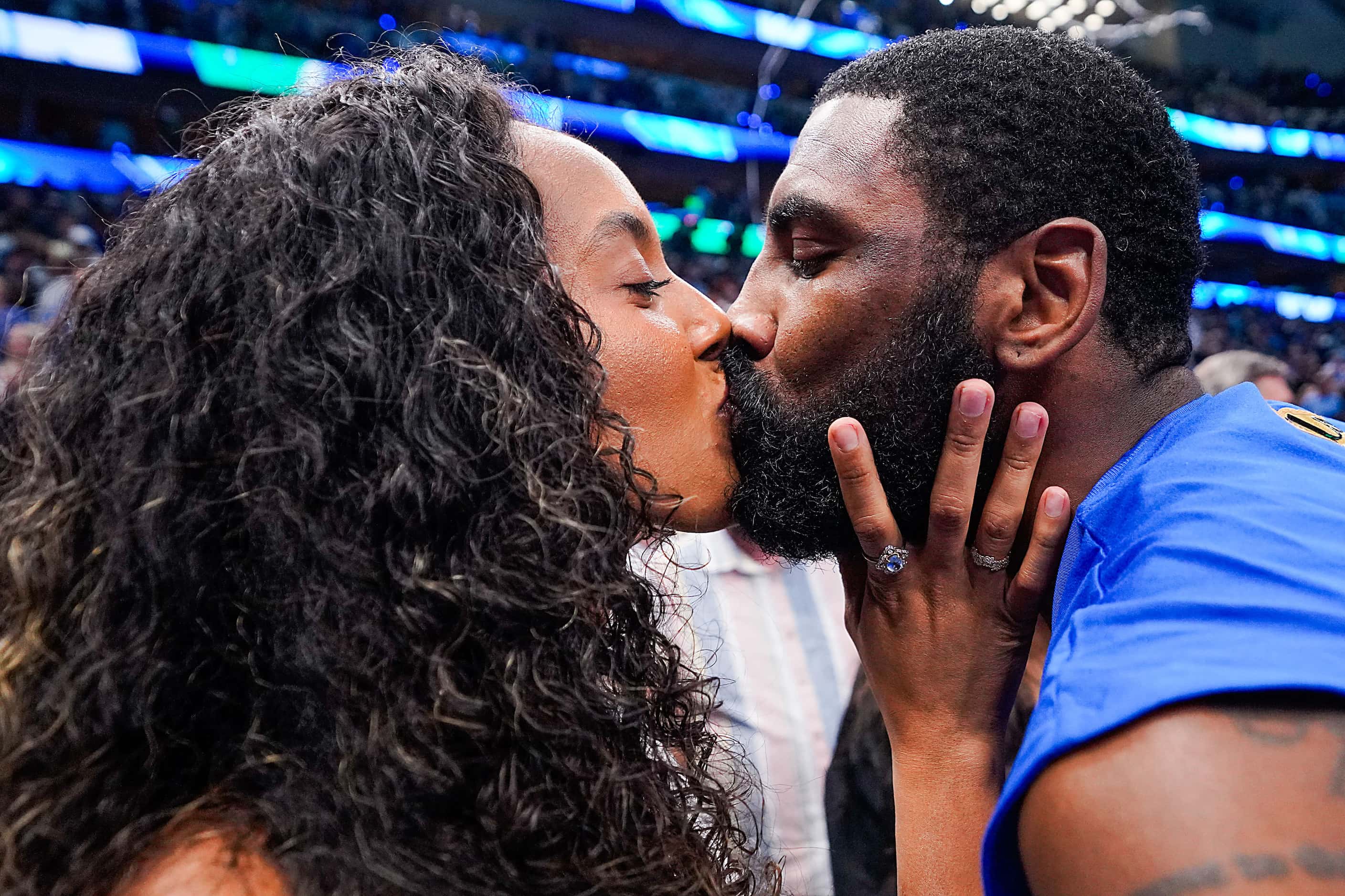 Dallas Mavericks guard Kyrie Irving kisses his wife Marlene Wilkerson after a victory over...