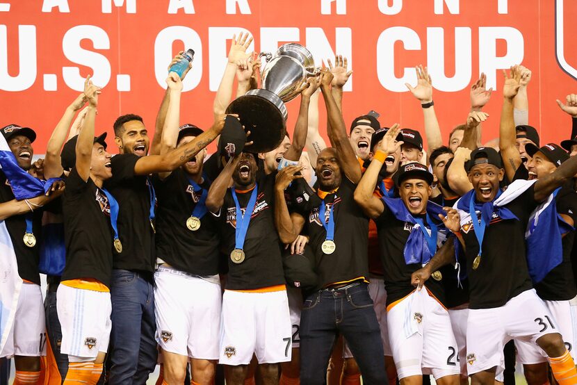 HOUSTON, TX - SEPTEMBER 26:  DaMarcus Beasley #7 of Houston Dynamo lifts up the championship...