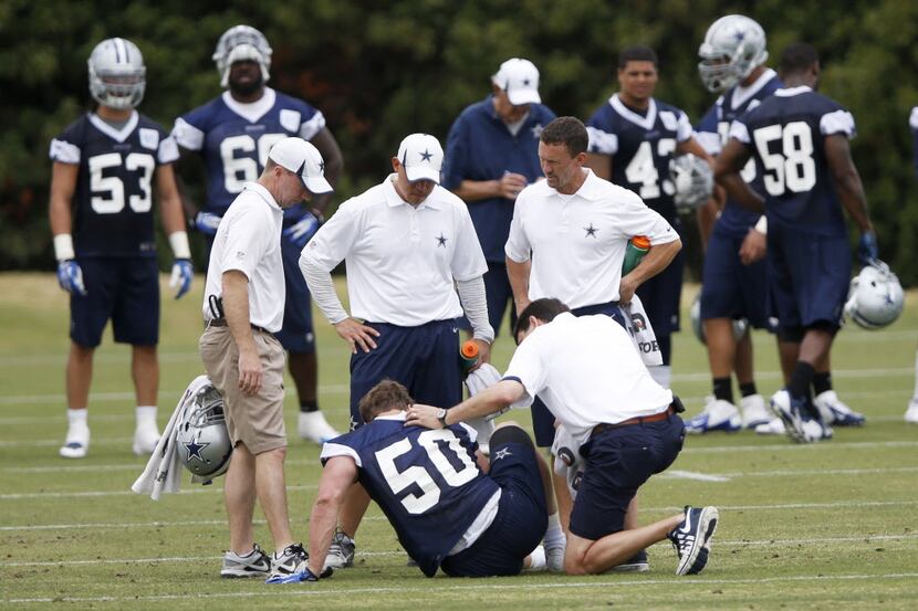 Dallas Cowboys staff tend to Dallas Cowboys linebacker Sean Lee after suffering an injury...