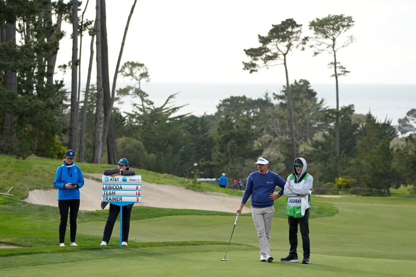 Hank Lebioda, second from right, waits to putt on the 18th green of the Monterey Peninsula...