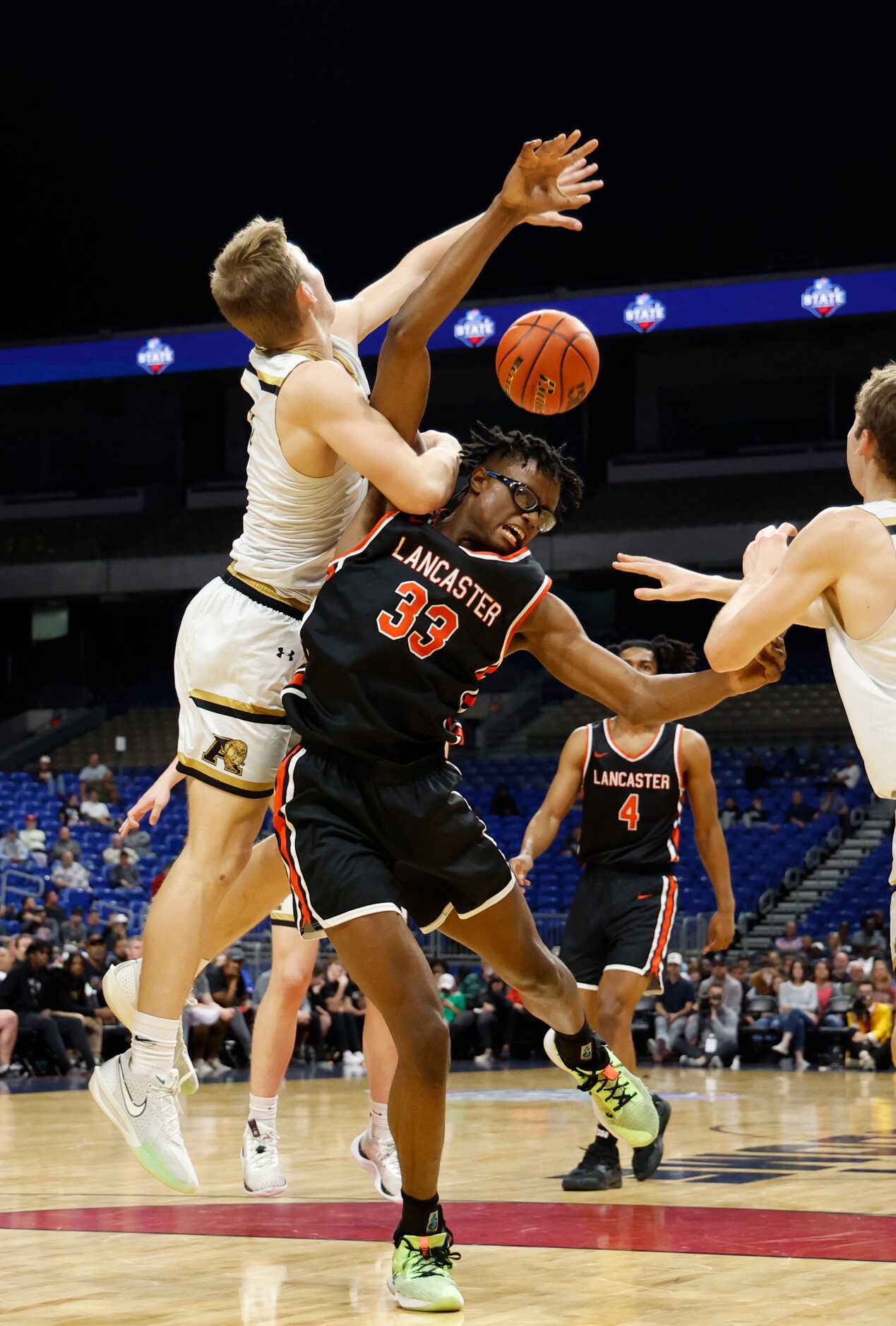 Lancaster's Amari Reed (33) battles Amarillo's TJ Brown (23) for a loose ball in the first...