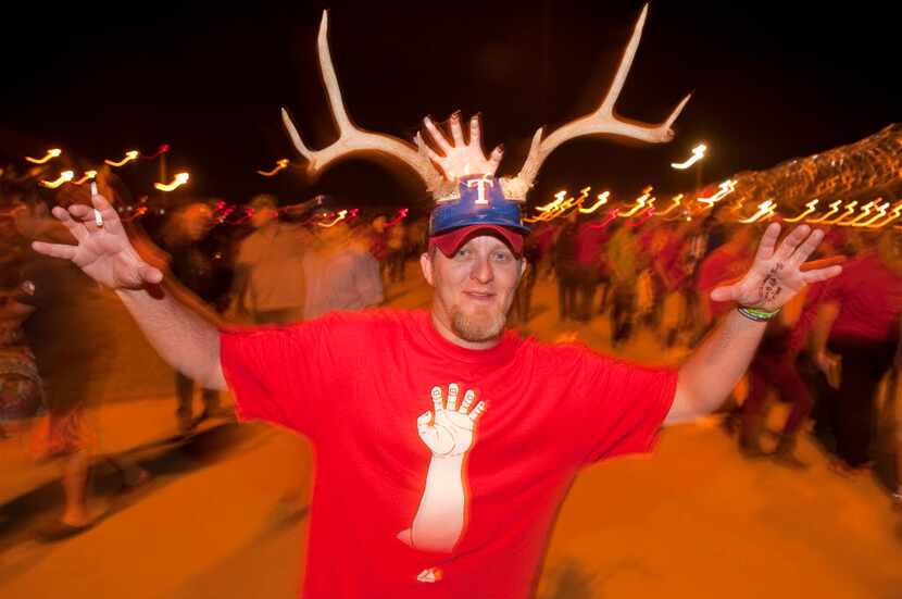 Jason Claxton of Bedford throws up his claws while displaying his personalized antler...