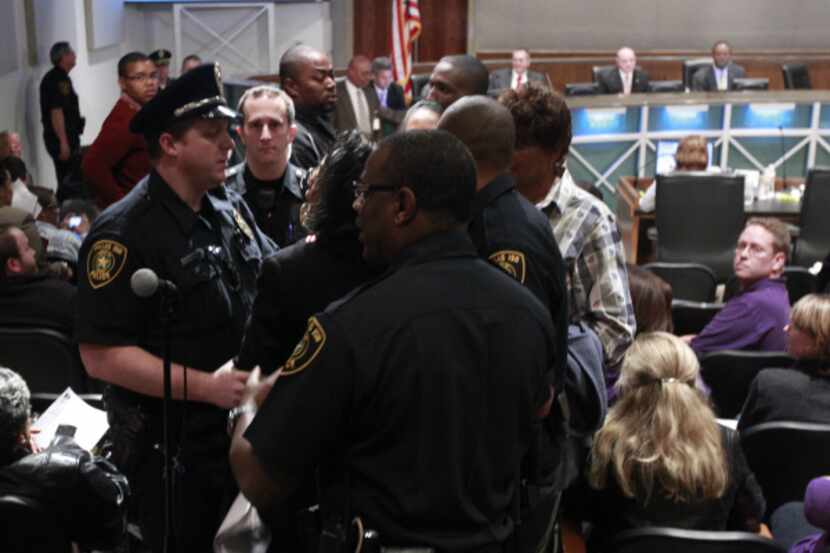 Joyce Foreman is removed by DISD police prior to a vote on a proposal  to close 11 schools...