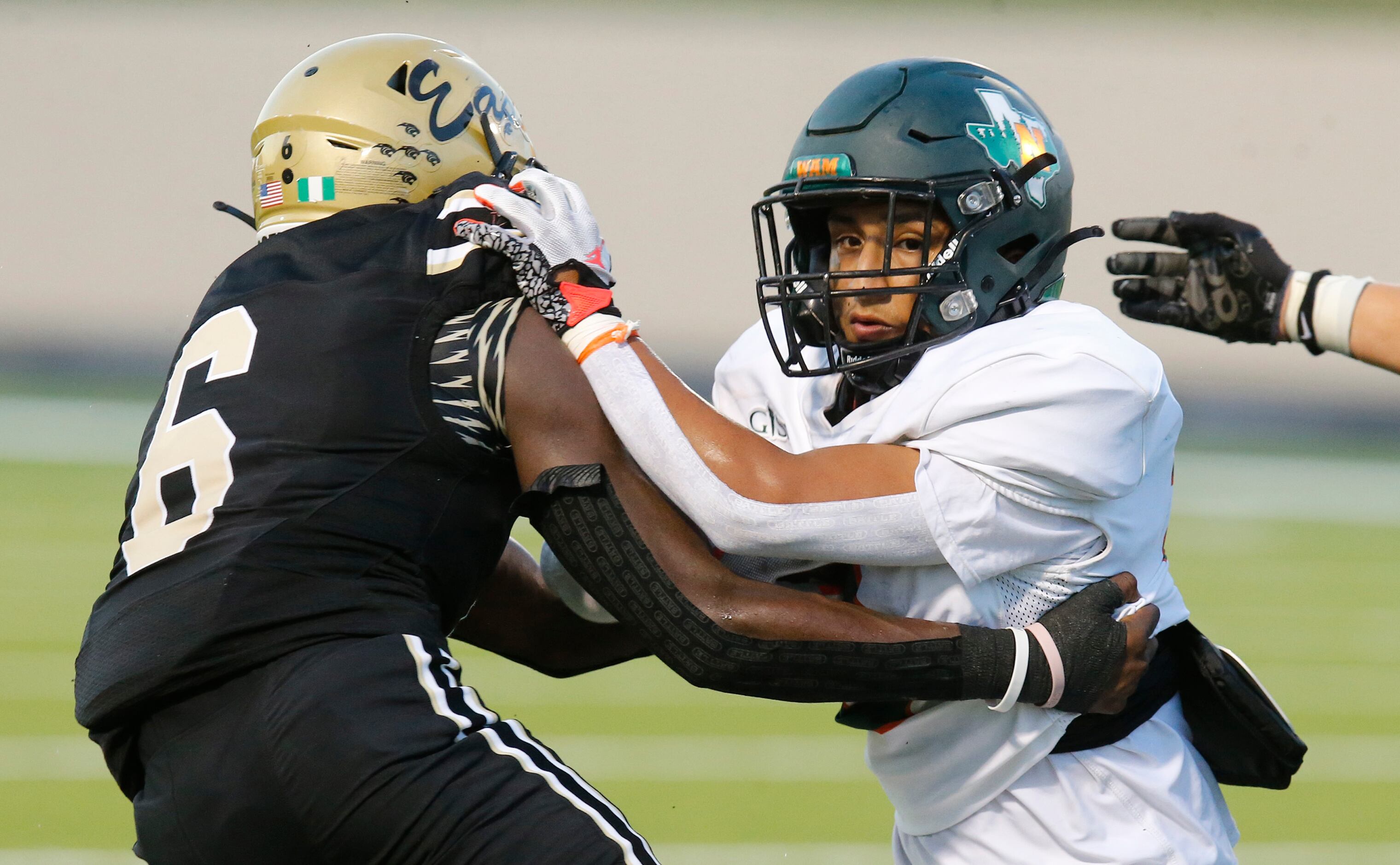 Naaman Forrest High School running back Ivan Garcia (2) is tackled by Plano East Senior High...