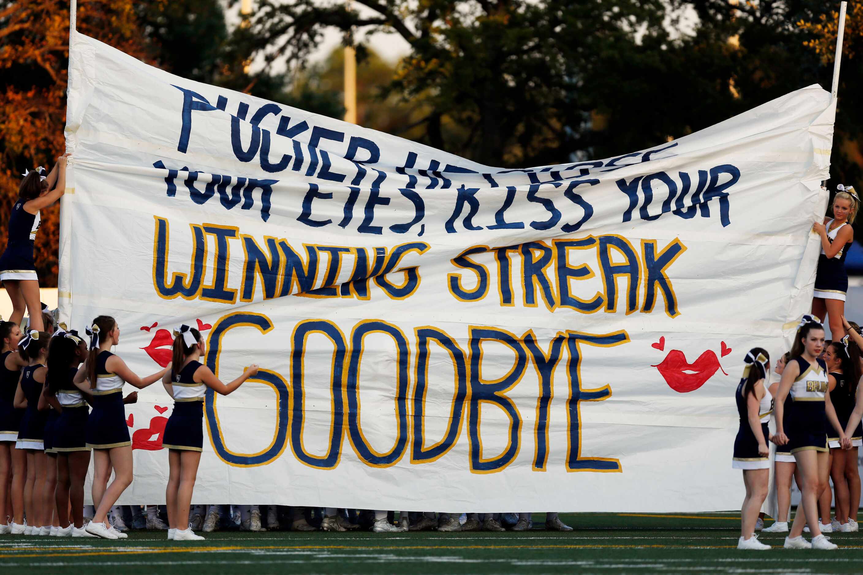 Pulaski Bruin cheerleaders hold a sign mocking the Highland Park home game winning streak...