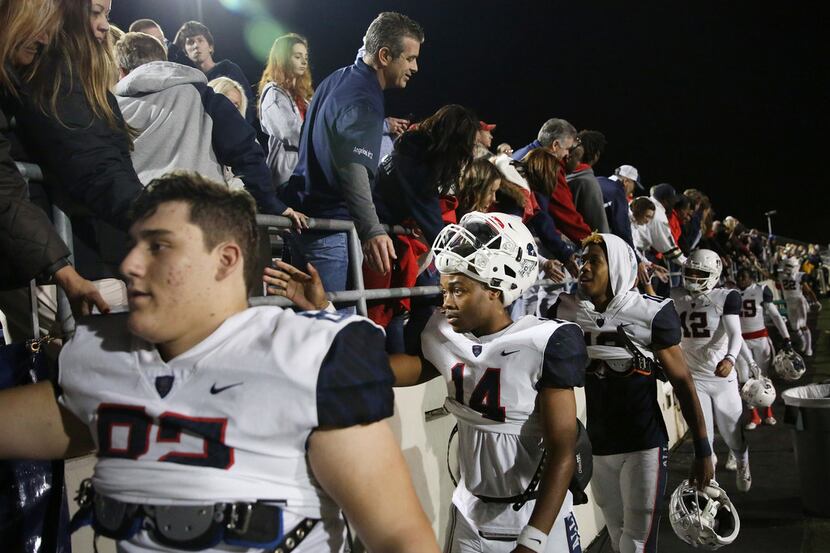 Allen quarterback Grant Tisdale (14) and teammates greet supporters following the Class 6A...