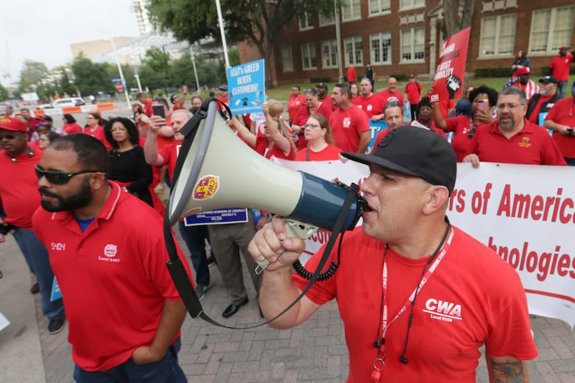 AT&T technician Armando Zepeda uses a bullhorn with members of the Commutation Workers of...