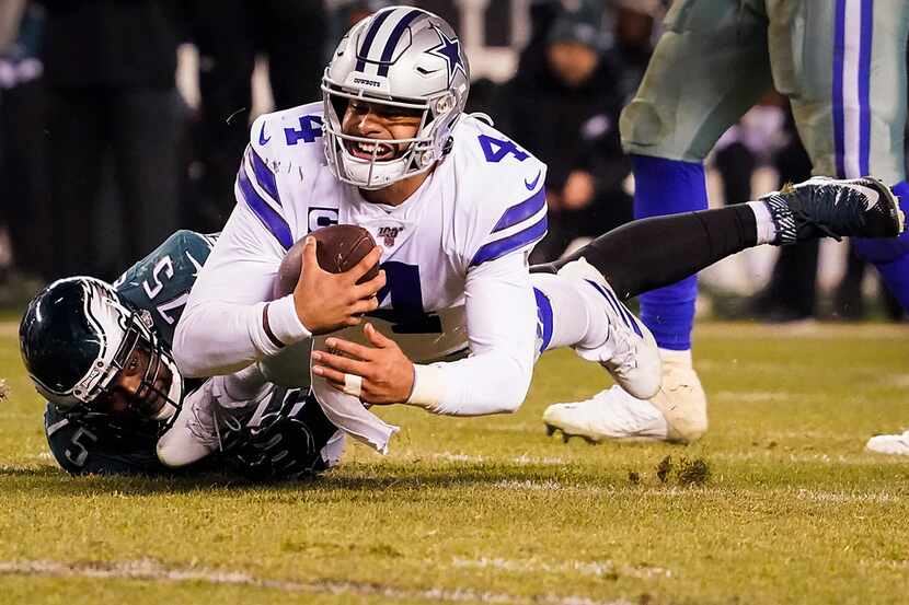 Dallas Cowboys quarterback Dak Prescott (4) is sacked by Philadelphia Eagles defensive end...