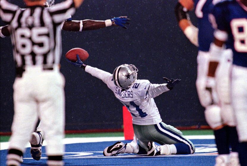 FILE - This Sept. 21, 1998, file photo shows Dallas Cowboys' Deion Sanders celebrating after...
