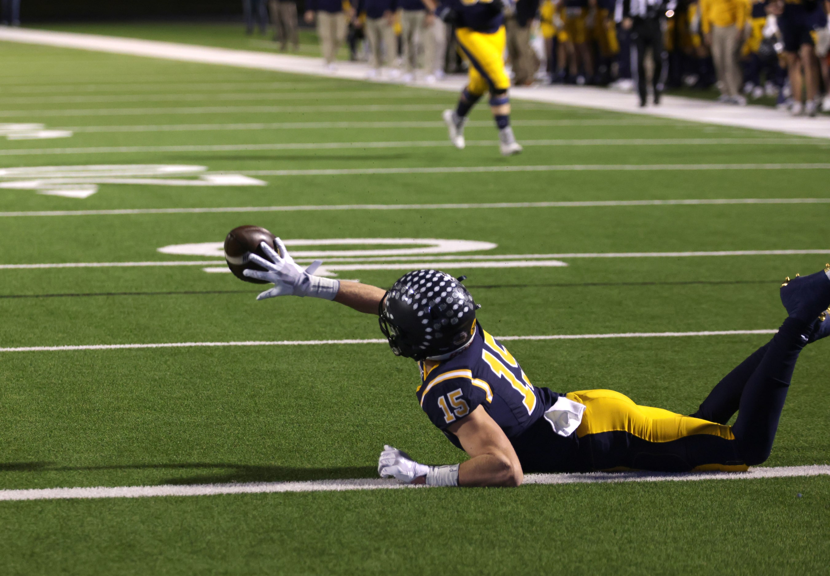 Highland Park's Benton Owens lays out in a high school football playoff game against Frisco...