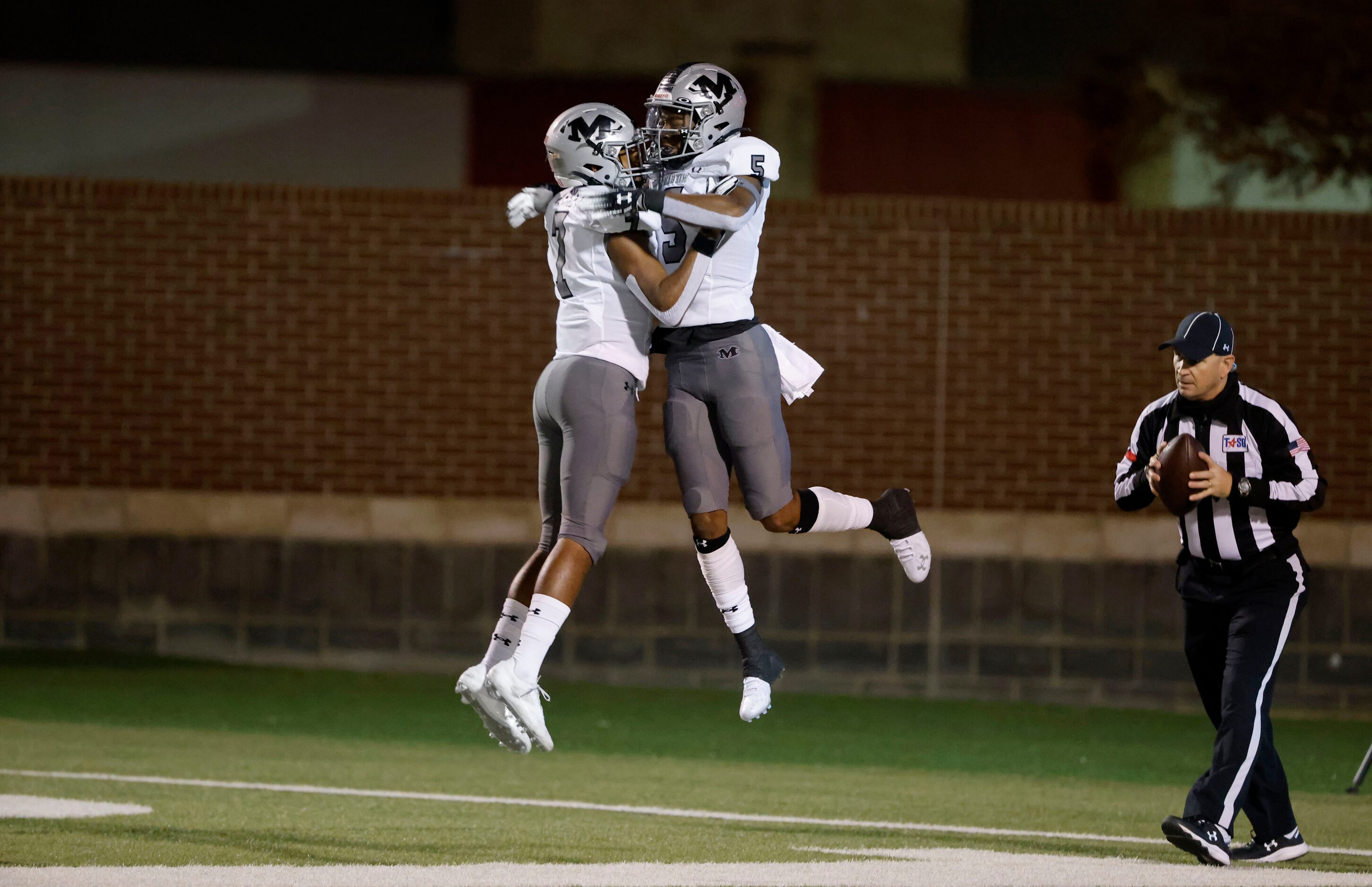 Arlington Martin’s Lenard Lemons (5) celebrates his touchdown with Kryon Askey (7), right,...