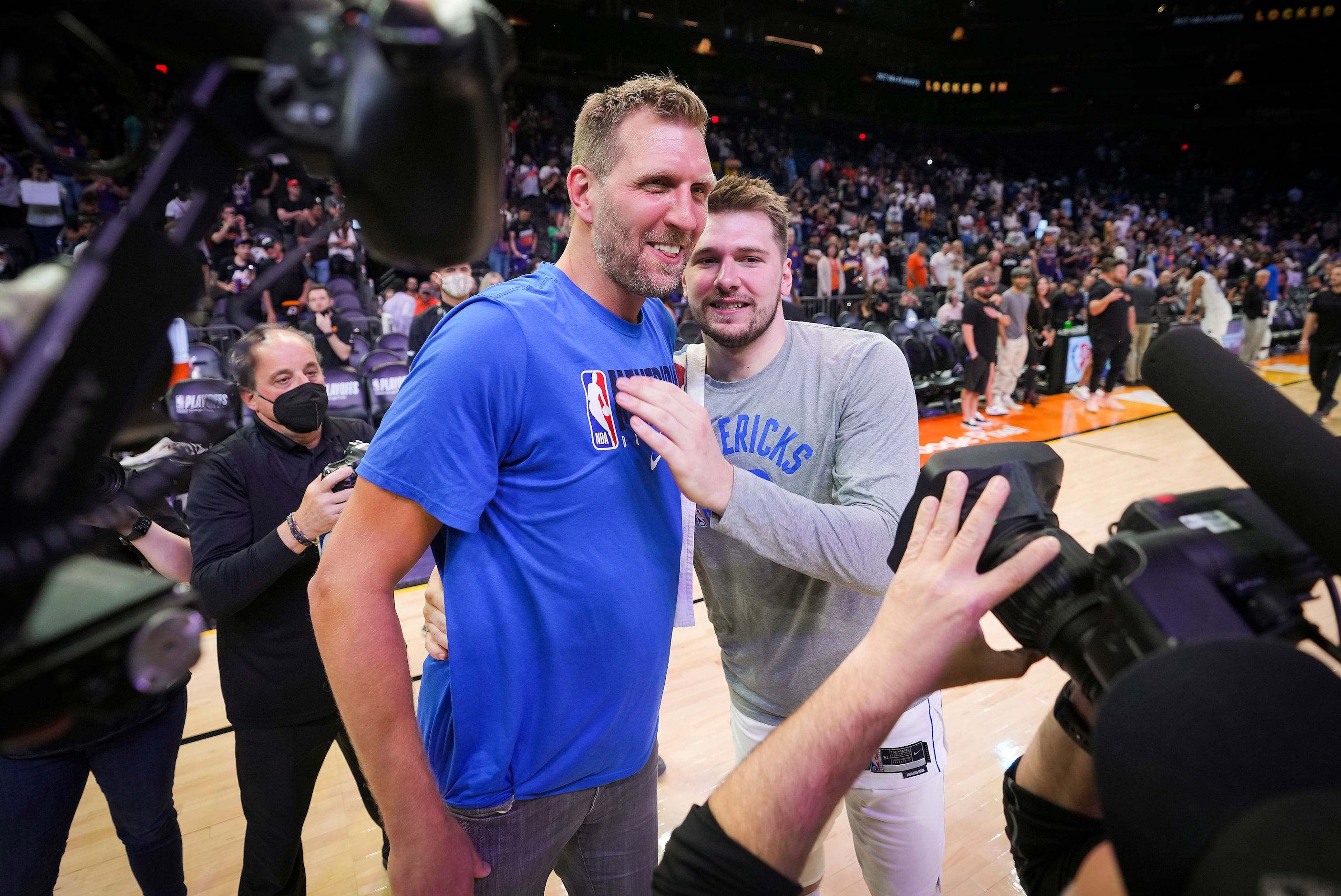 Dallas Mavericks guard Luka Doncic celebrates with Mavericks great Dirk Nowitzki (left)...