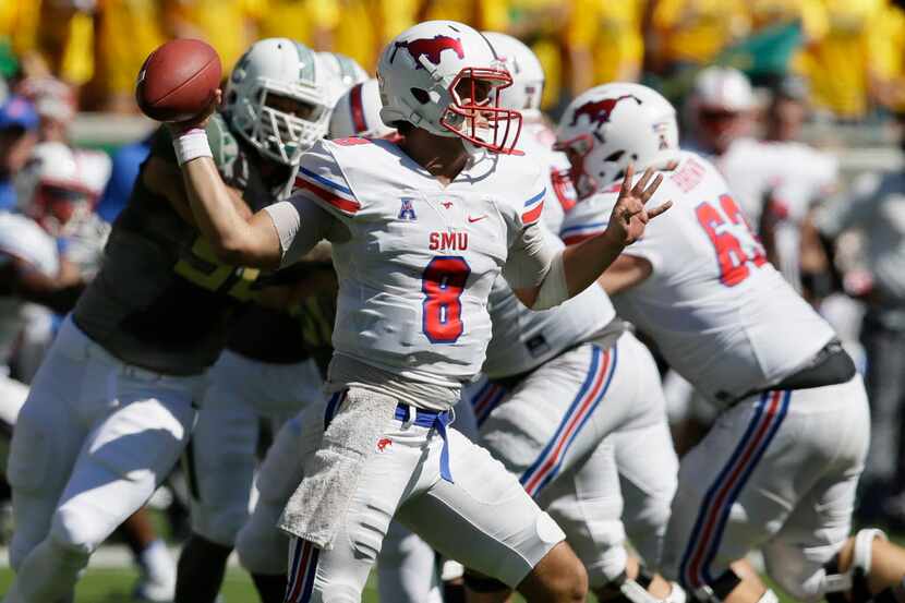 SMU quarterback Ben Hicks (8) passes during the first half of an NCAA college football game...