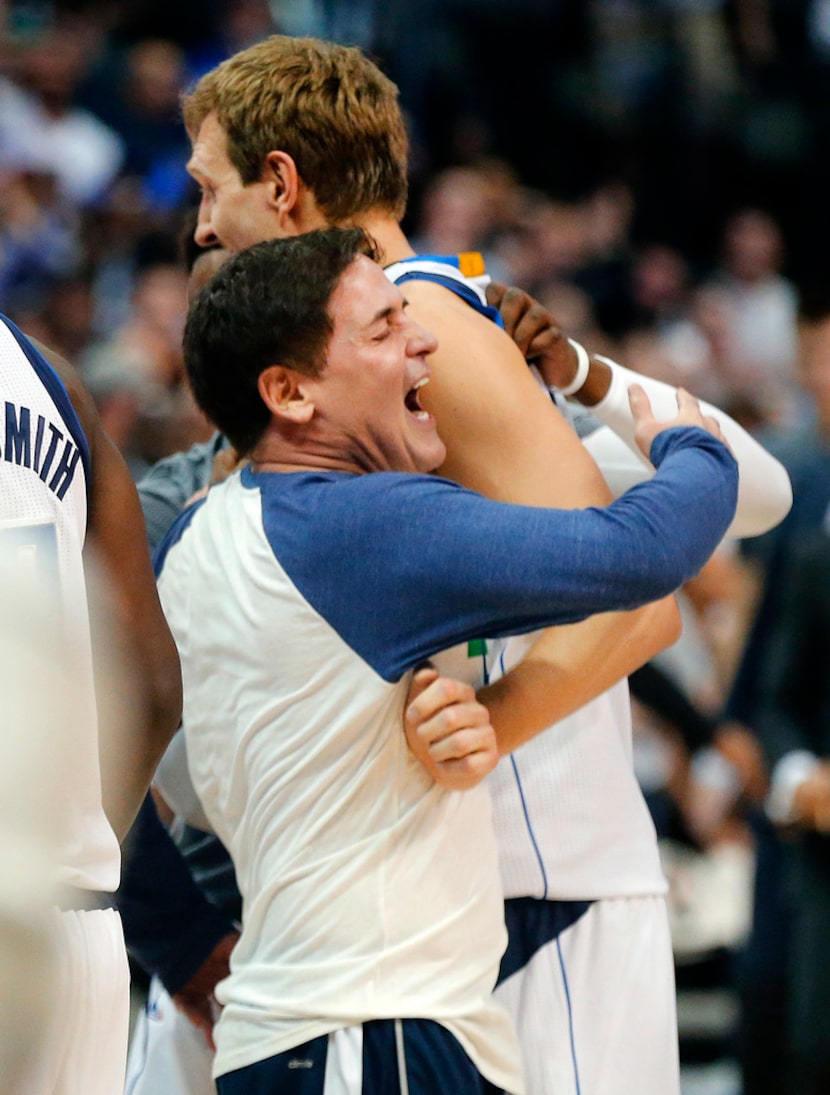 Dallas Mavericks owner Mark Cuban celebrates with Dirk Nowitzki after his 30,000 point...