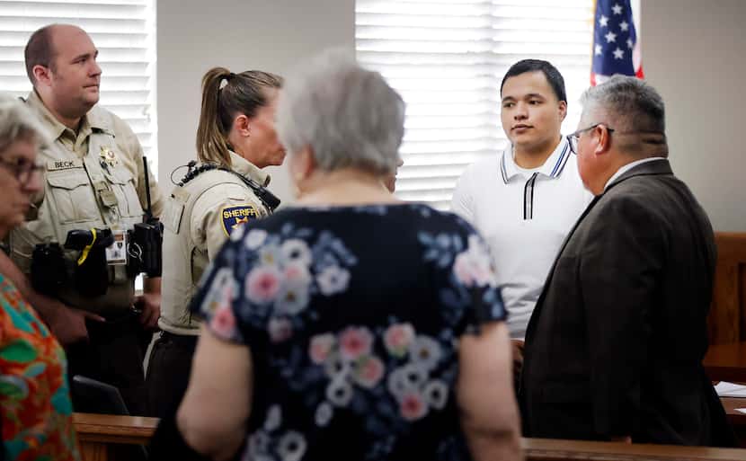 Defendant Jasinto Jimenez, 22, of Wichita Falls, Texas, (second from right) waits to be...