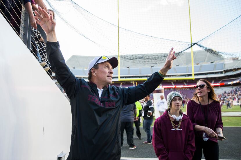 Texas A&M Aggies head coach Jimbo Fisher waves to fans after a Texas A&M University Maroon...
