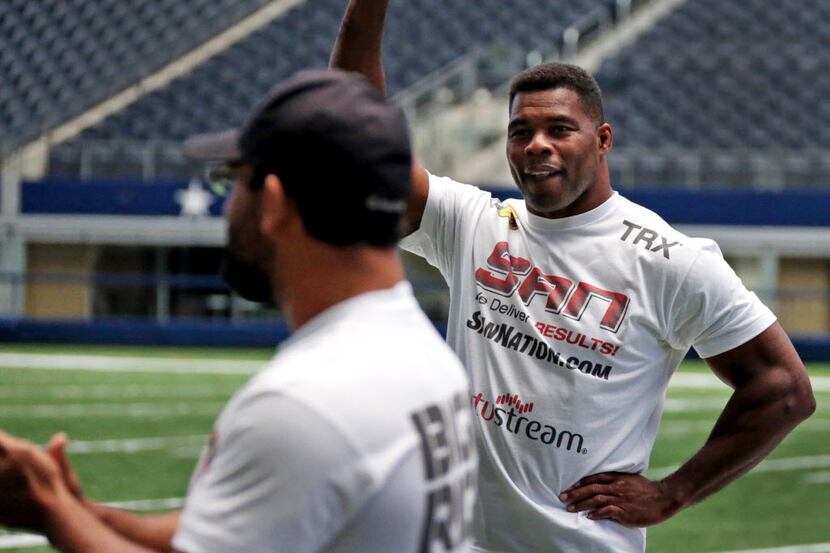 Former Cowboys running back Herschel Walker acknowledges cheers from the crowd as the UFC...