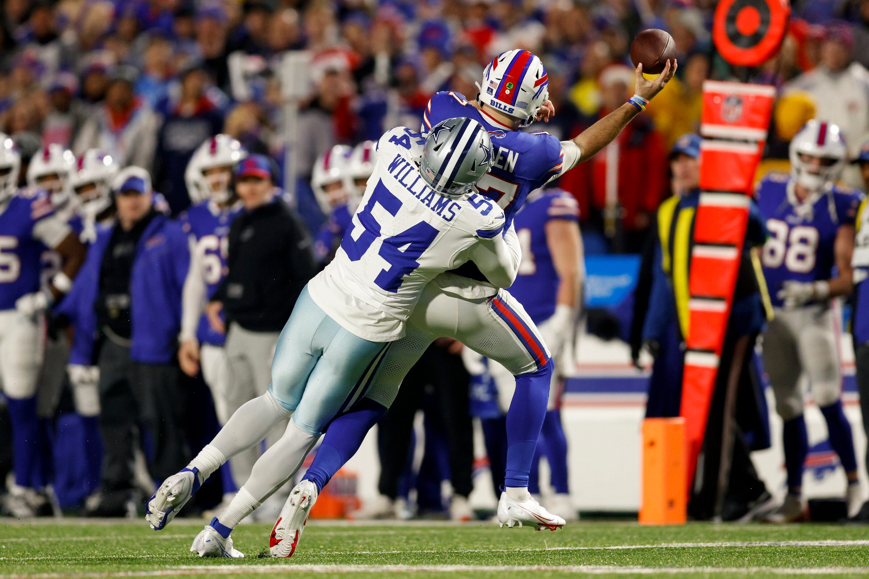 Dallas Cowboys defensive end Sam Williams (54) hits Buffalo Bills quarterback Josh Allen...