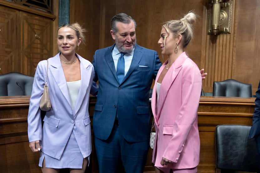 Sen. Ted Cruz, R-Texas, center, talks to former University of Miami student athlete Hanna...