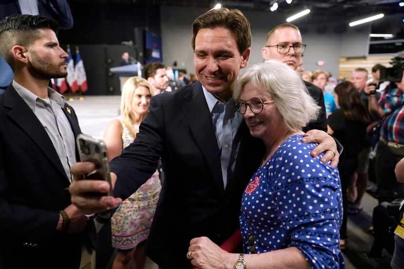 FILE - Republican presidential candidate Florida Gov. Ron DeSantis poses for a photo with...