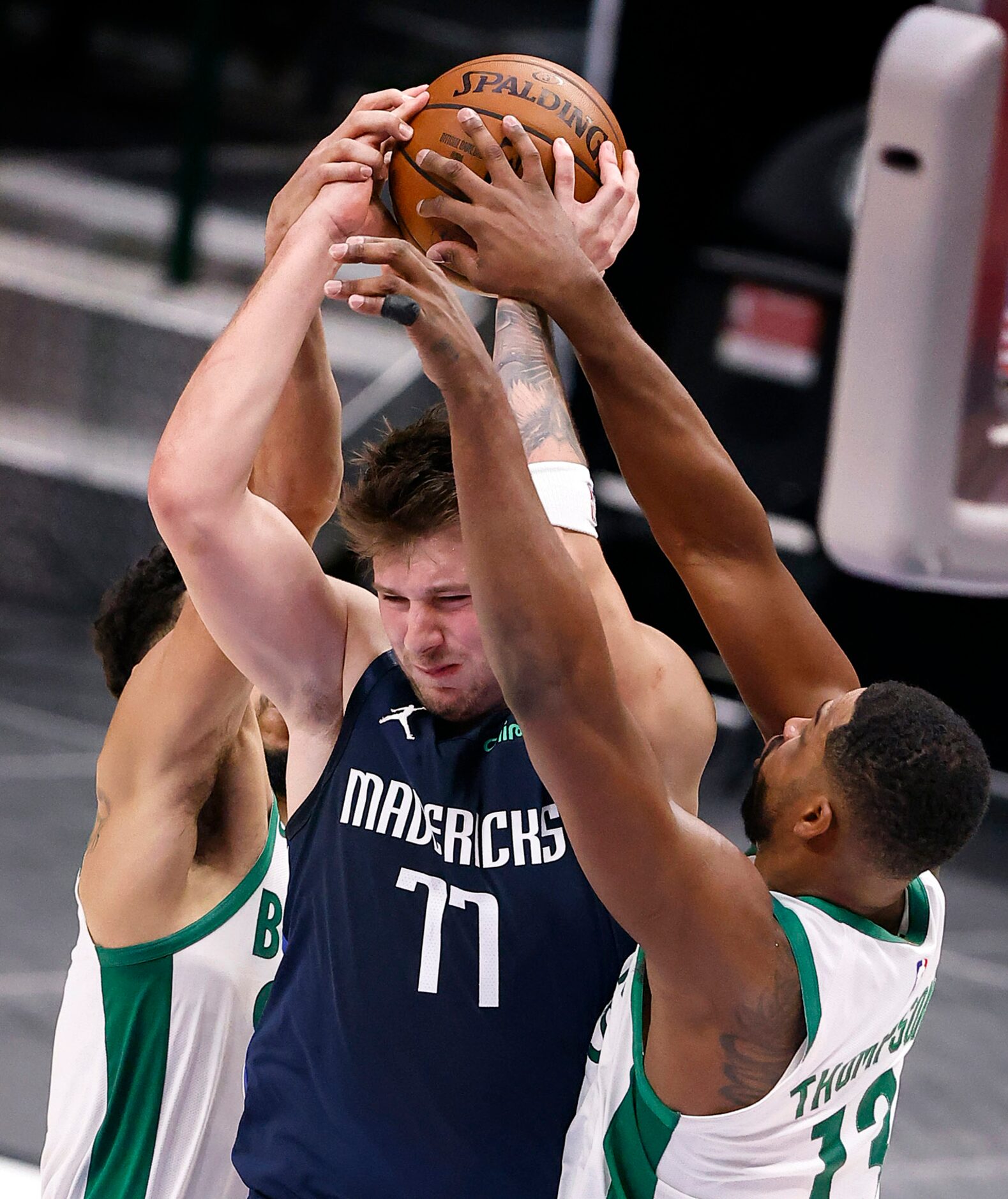 Dallas Mavericks guard Luka Doncic (77) has the ball stripped away from him by Boston...