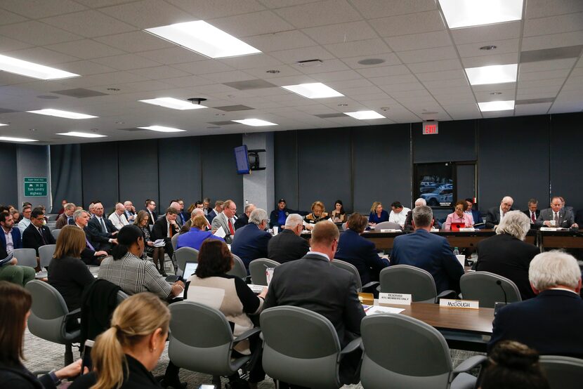 People sit during a meeting of the Regional Transportation Council at the North Central...