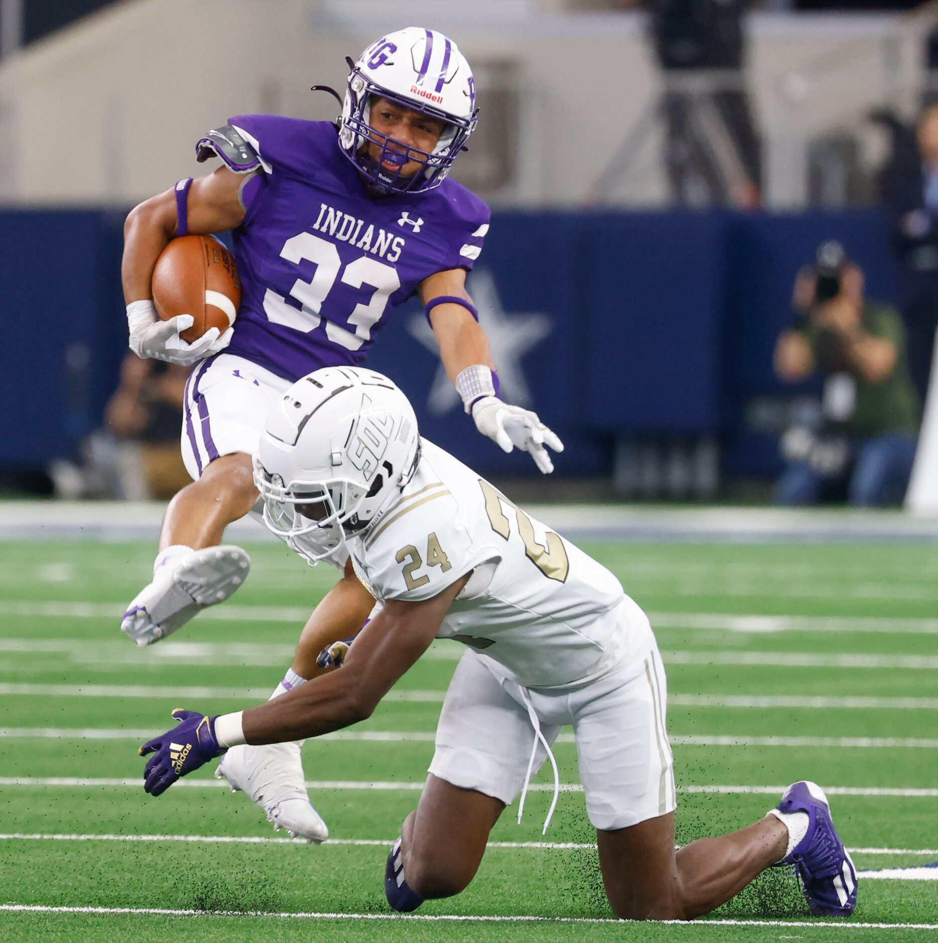 Port Neches-Groves’ Isaiah Nguyen (33) gets tackled by  South Oak Cliff’s safety Tobias Gary...