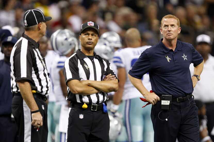 Dallas Cowboys head coach Jason Garrett watches the video replay after he threw a red flag...