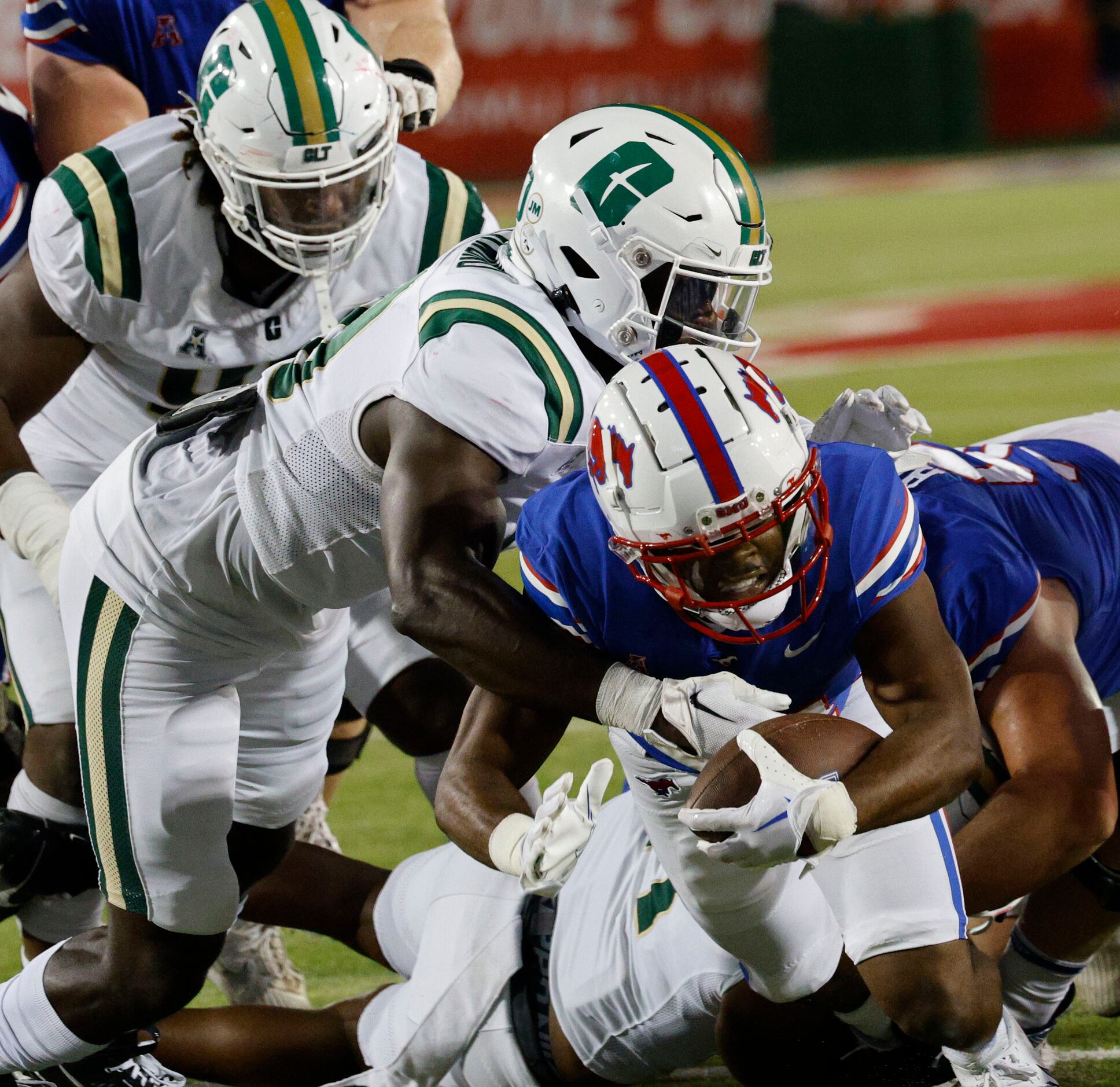 Charlotte 49ers defense players try to stop SMU running back Velton Gardner (24) during the...