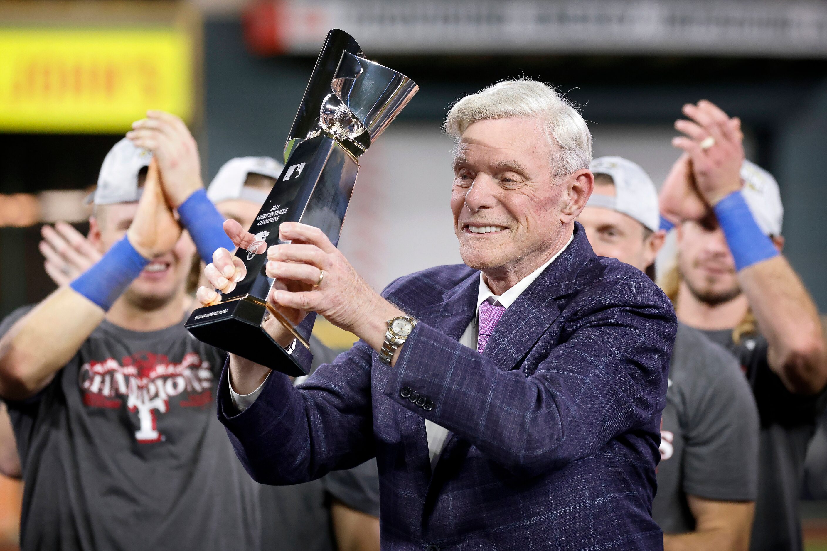 Texas Rangers co-owner Ray Davis hoist the winning ALCS trophy after defeating the Houston...