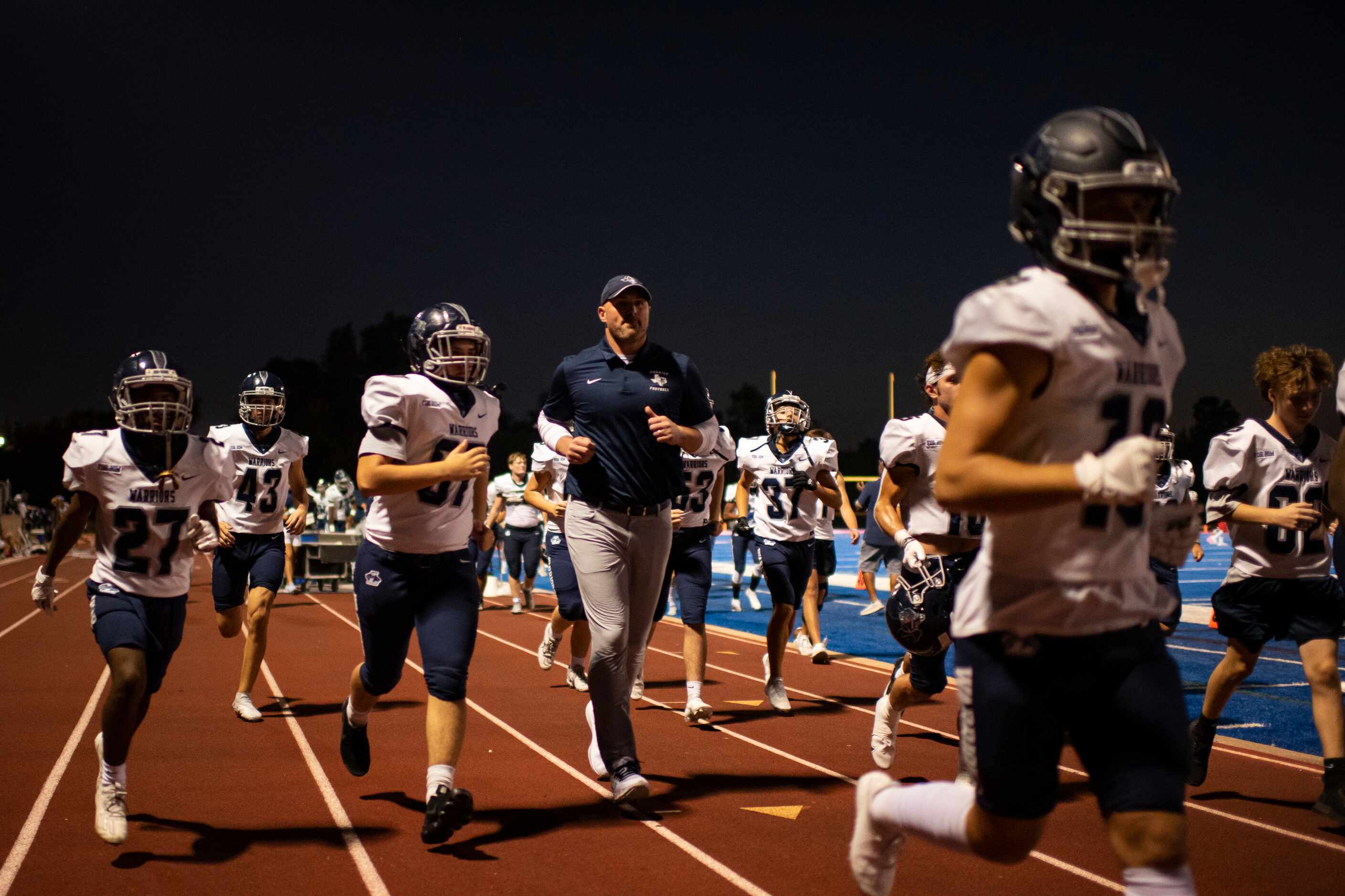 Argyle Liberty Christian Head Coach Jason Witten jogs back with his players to the locker...