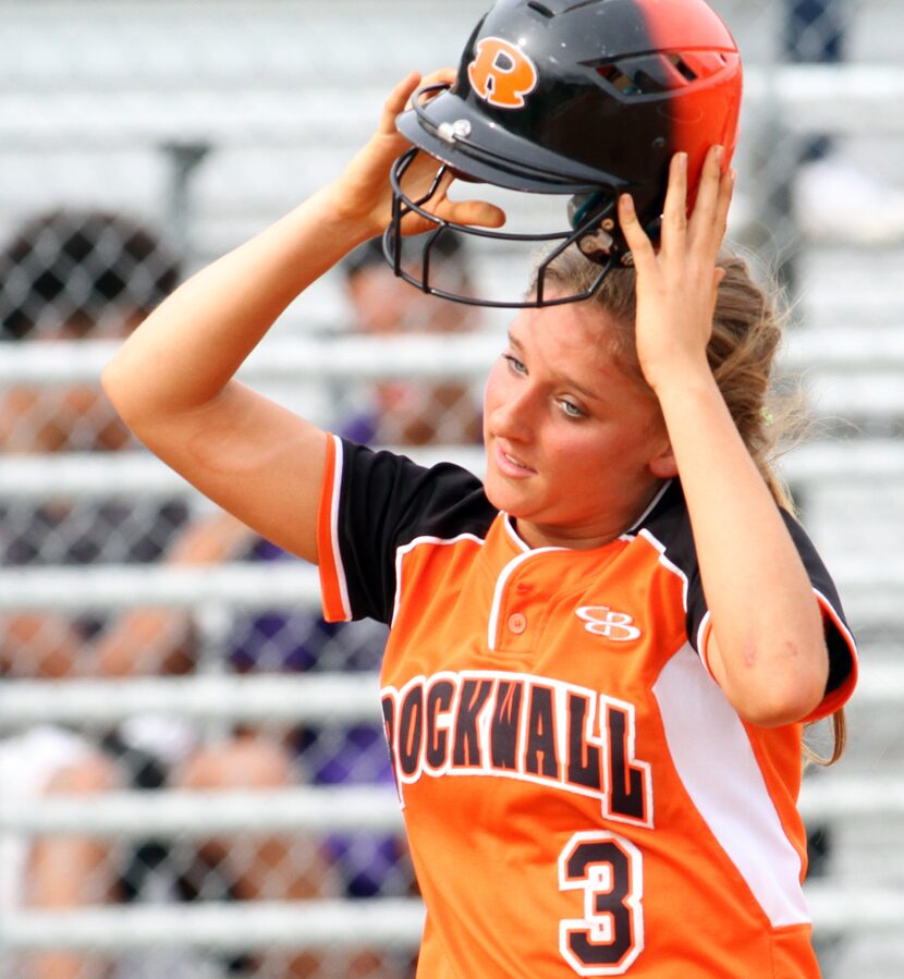 Rockwall's Dani Greenlee (3) removes her helmet after being stranded on base as the top of...