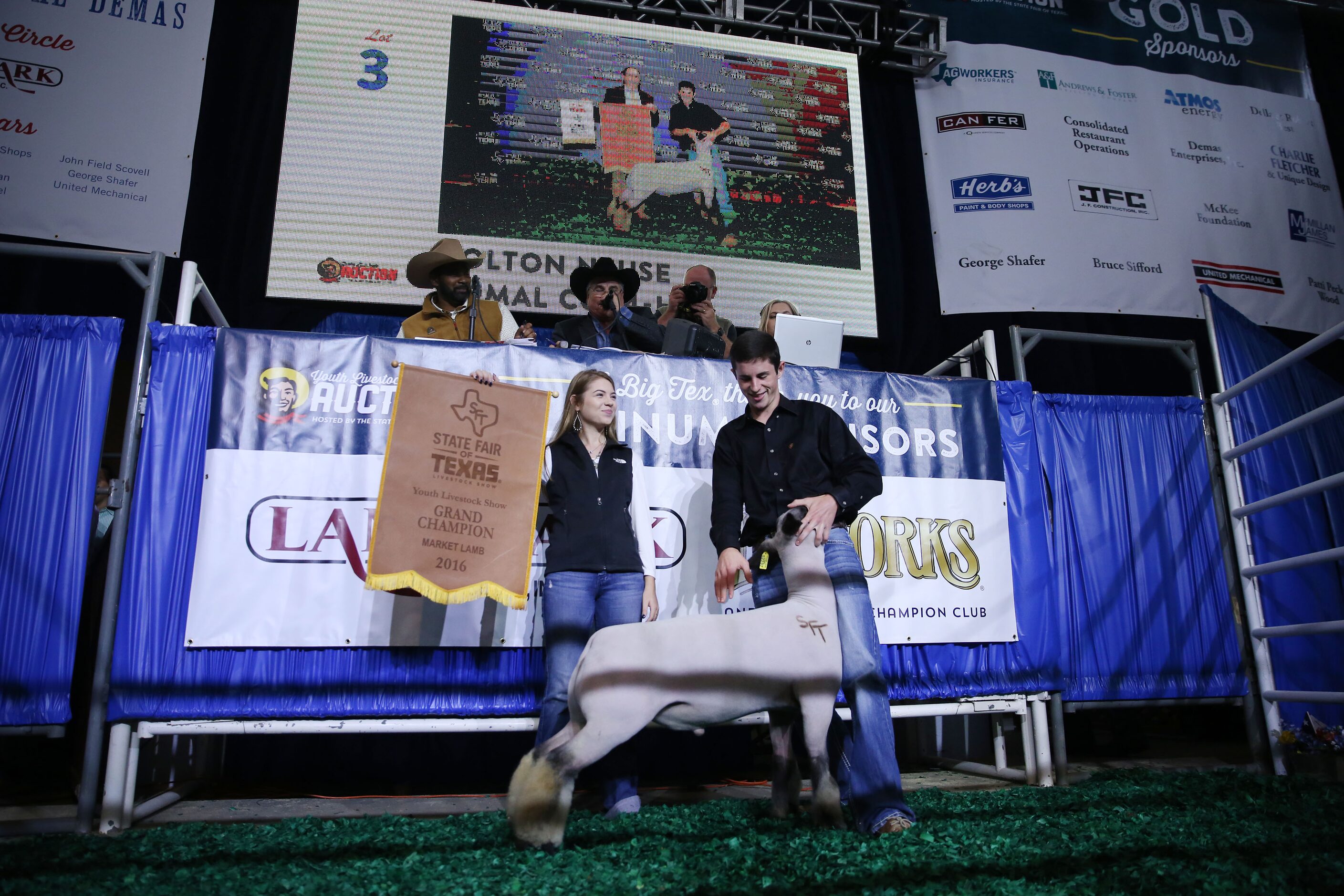 Kolton Neuse (right) stands with his grand champion lamb and friend, Morgan Hollingsworth...