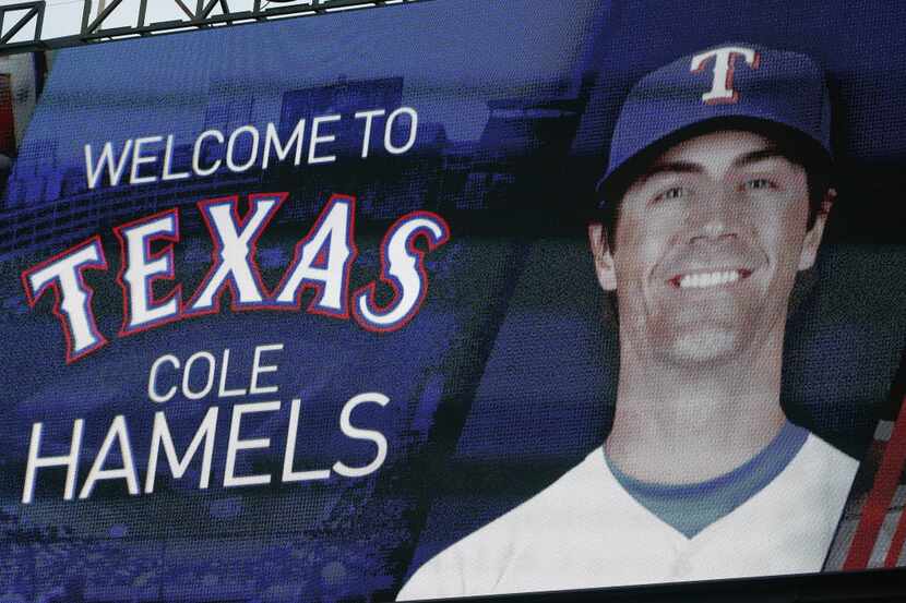 A sign reading "Welcome to Texas Cole Hamels" is flashed on the scoreboard at Globe Life...