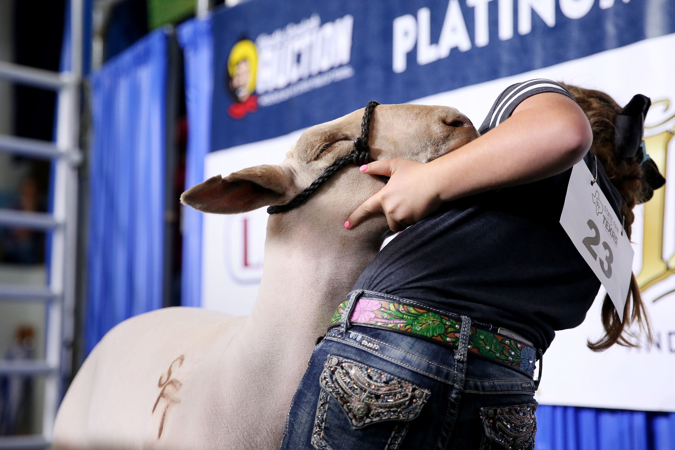 Ella Rea, 10, of San Angelo, Texas, stands with her champion lamb during the State Fair of...