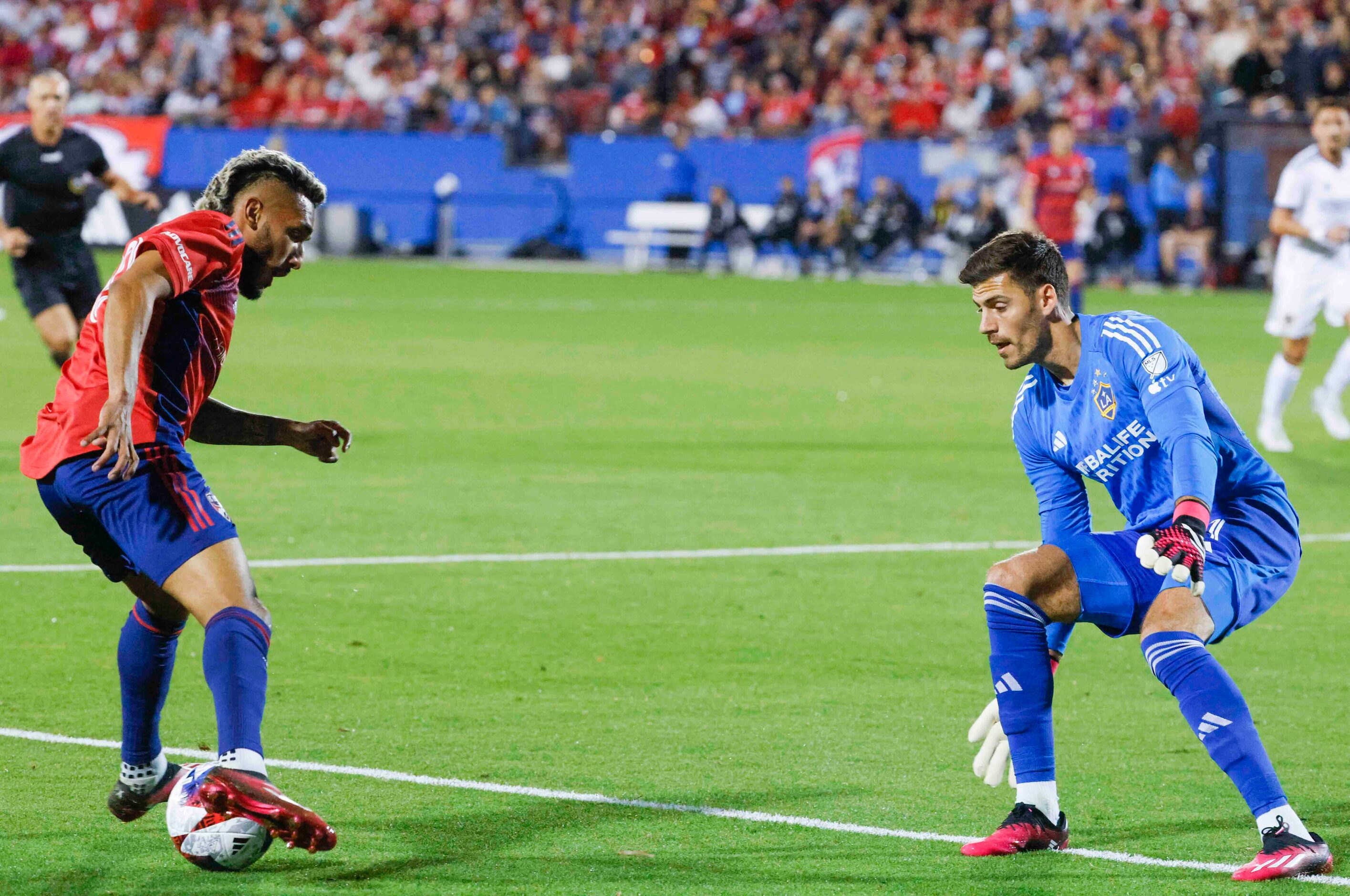 FC Dallas forward Jesús Ferreira (left) dribbles against Los Angeles Galaxy goalkeeper...