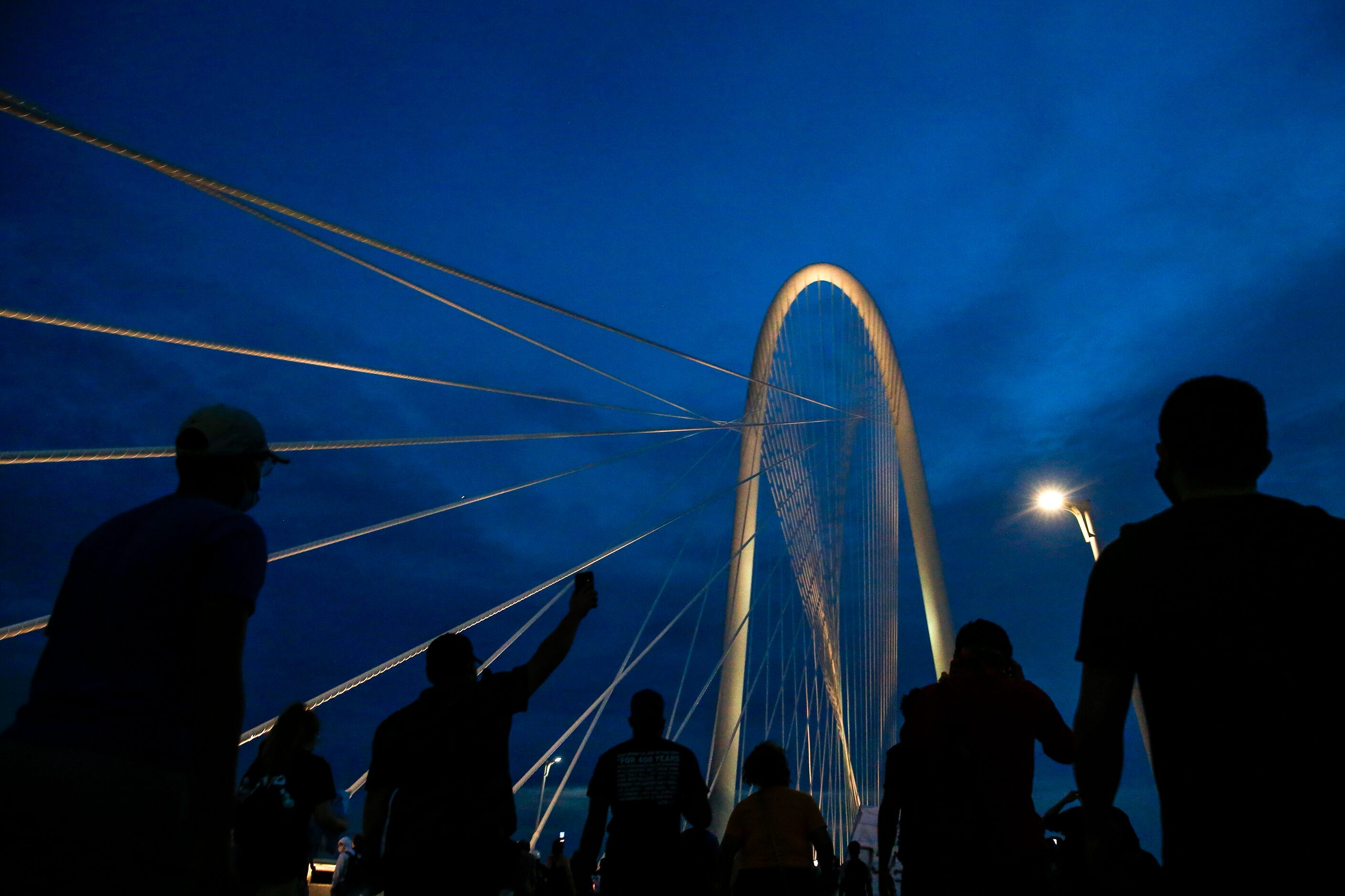 Protesters march onto the Margaret Hunt Hill Bridge as the demonstrate against police...