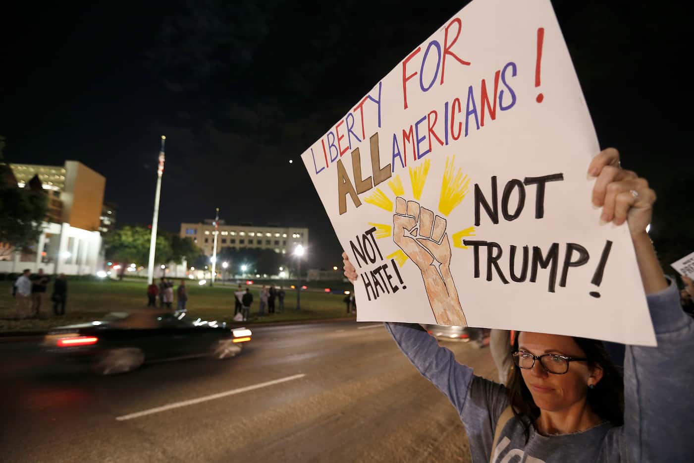 Melissa Martin, a protester against President-elect Donald Trump, holds up a sign during a...