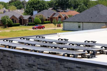 Solar panels cover part of a residential rooftop in Frisco, Texas, Friday, July 15, 2022.