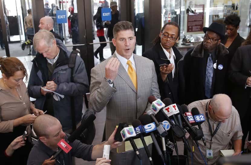 Attorney Daniel Herbert, center, talks to reporters after the bond hearing for his client,...