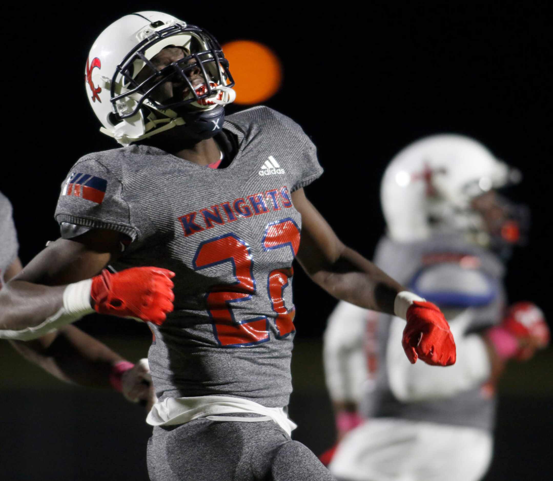 Dallas Kimball defensive back Perry Taylor (22) lets out a yell after recovering a fumble...