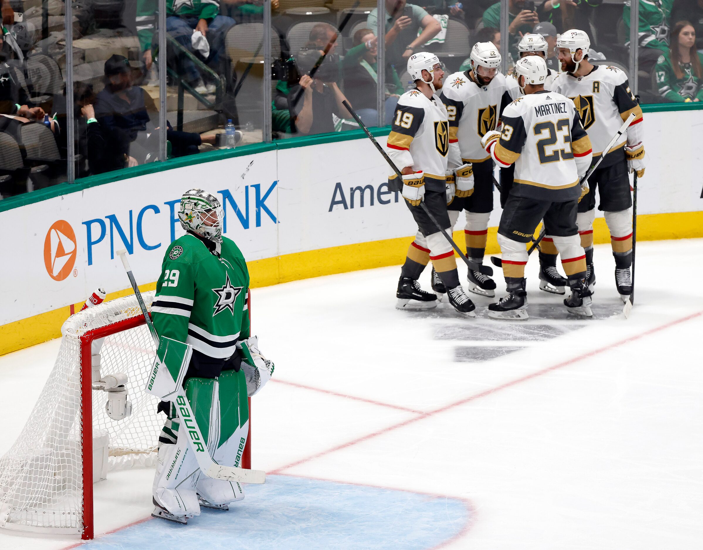 Vegas Golden Knights players congratulate right wing Michael Amadio (22) on his third period...