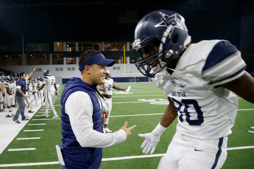 Frisco Lone Star head coach Jeff Rayburn (left) celebrates a 41-16 win over The Colony with...