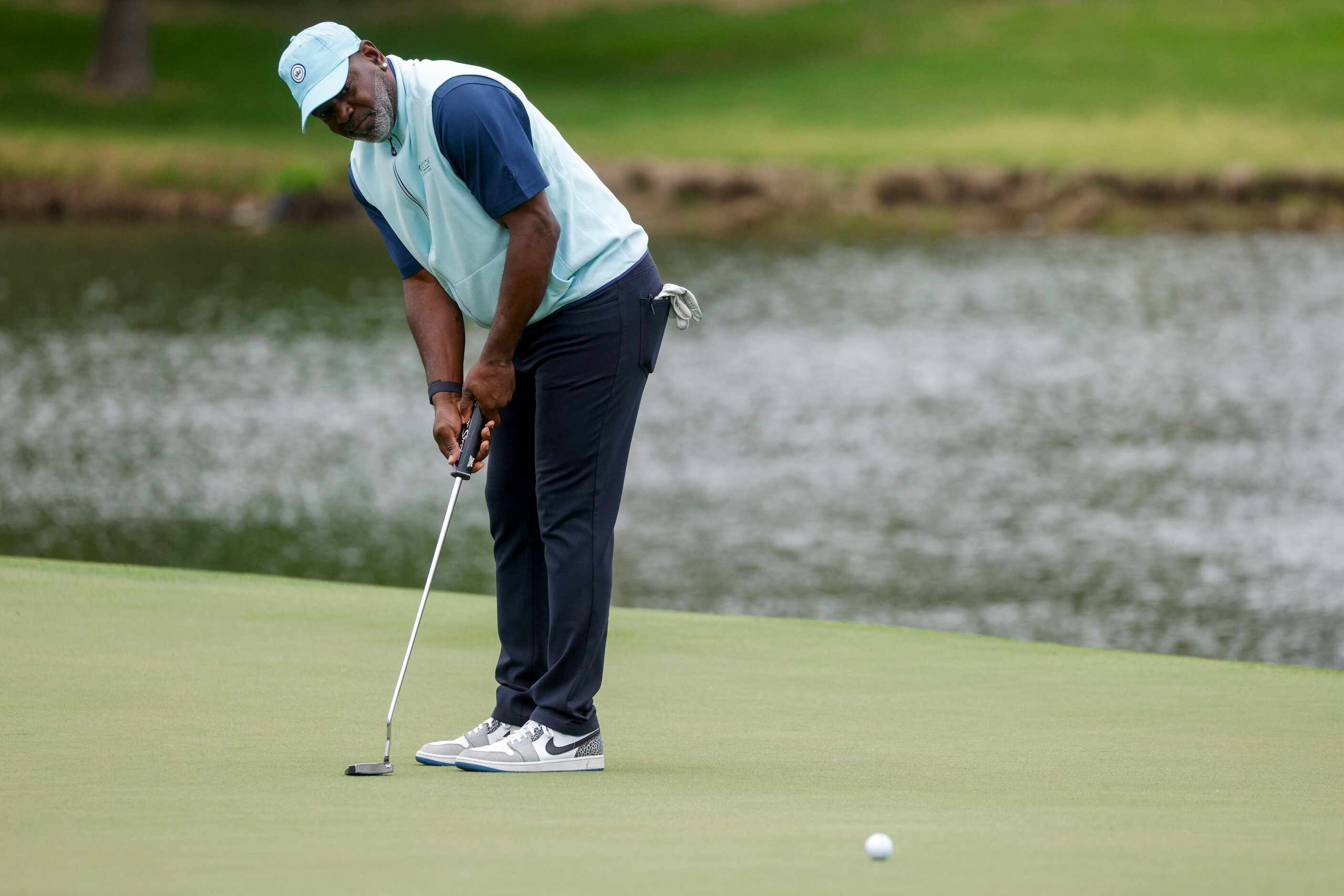 Former Dallas Cowboys running back Emmitt Smith watches his putt on the 18th green during...
