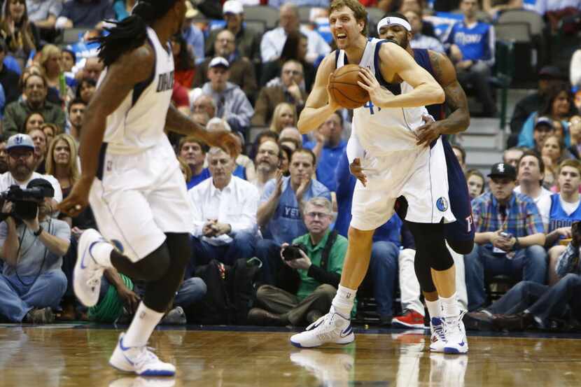 Dallas Mavericks power forward Dirk Nowitzki passes to teammate Dallas Mavericks small...