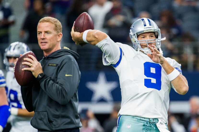Dallas Cowboys quarterback Tony Romo (9) warms up alongside Dallas Cowboys head coach Jason...