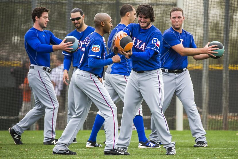 Texas Rangers pitcher Sam Freeman (front left) works with teammate pitcher Luke Jackson on a...